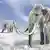 Woolly mammoths walking in a snow-covered field