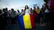 A woman holds a flag of Romania during a gathering in front of the Romanian Prime Minister's office building A woman holds a flag of Romania during a gathering in front of the Romanian Prime Minister's office building