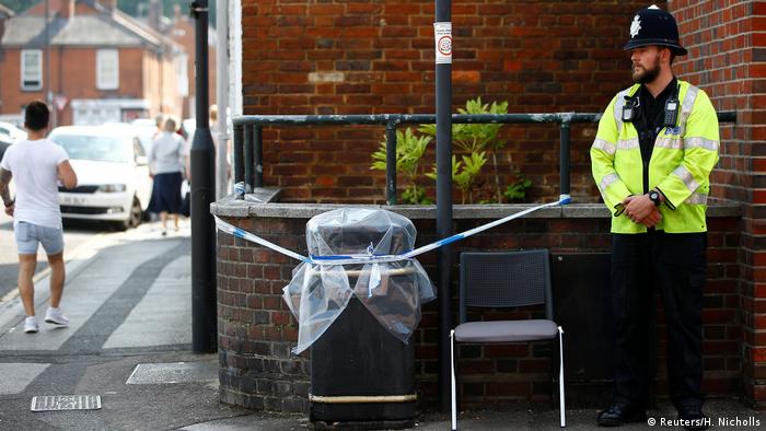 A police officer guards a cordoned-off rubbish bin in Salisbury, England