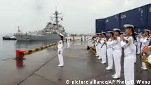 FILE - In this Aug. 8, 2016 file photo, a Chinese military band plays as the guided missile destroyer USS Benfold arrives in port in Qingdao in eastern China's Shandong Province in the first visit by an American warship to the country since Beijing responded angrily to an arbitration panel's ruling that its expansive South China Sea maritime claims had no basis in law. A senior Chinese diplomat made clear Monday, Aug. 15, that Beijing wants next month's meeting of leaders of the Group of 20 major economies to avoid political issues such as its territorial disputes with its neighbors in the South China Sea. (AP Photo/Borg Wong, File) |
