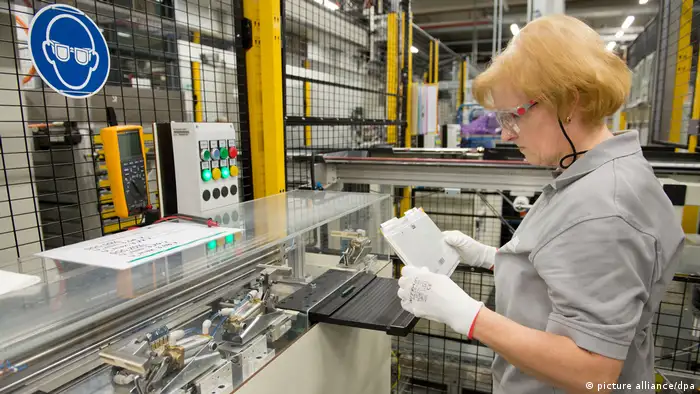ACCUmotive employee looking at a battery cell for a SMART III battery