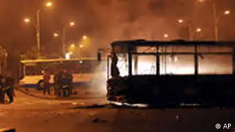 In this photo released by China's Xinhua News Agency, firefighters put out a fire on a bus in Dawannanlu Street in Urumqi, capital of China's Xinjiang Uygur Autonomous Region on Sunday, July 5, 2009. Nearly 1,000 protesters from a Muslim ethnic group rioted in China's far west, overturning barricades, attacking bystanders and clashing with police in violence that killed at least three people, including a policeman, state media and witnesses said. (AP Photo/Xinhua, Shen Qiao) ** NO SALES **