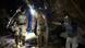 men in full gear pulling something from cave men in full gear pulling something from cave