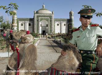 A Han Chinese paramilitary police officer rides a camel at the Apak Hojak Tomb, established in 1640 to commemorate the late influential king of the Islamic Uyhgur ethnic group in Kashgar, China's Xinjiang Uyghur Autonomous Region, Monday 29 August 2005. The Islamic Uyghurs comprise 75% of Kashgar's population and are the largest ethnic group in the autonomous region yet major industries such as oil, transportation and banking are controlled by Beijing. Xinjiang, which is five times geographically larger than France, was once a thriving part of the Silk Road until after the Tang Dynasty (618AD - 907AD) but is now mired in poverty compared with other regions of China. Foto: MICHAEL REYNOLDS +++(c) dpa - Report+++