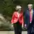 Donald Trump and Theresa May walk together to their joint press conference on the grounds of Chequers