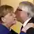 Jean-Claude Juncker kissing Angela Merkel