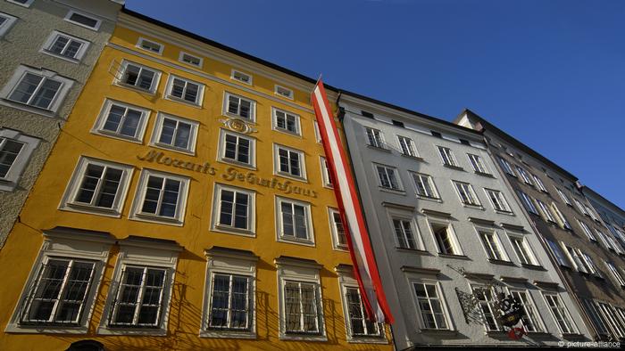 A low-angle view of Mozart's old home, in mustard yellow. 