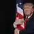 Donald Trump hugs an American flag