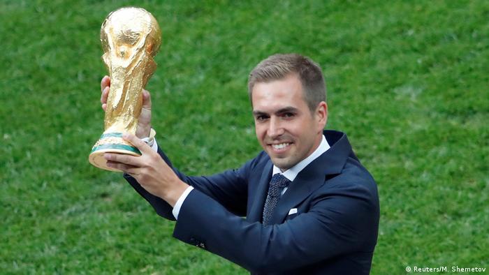 Former Germany captain Philipp Lahm holding the World Cup trophy in Moscow, Russia, in 2018.