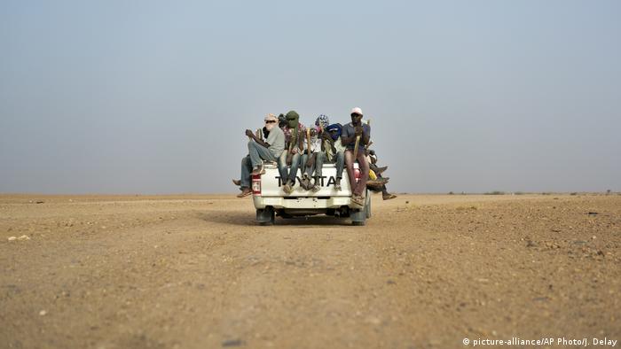 Migrants in the sahara on a truck