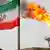 An Iranian flag stands next to an oil production platform