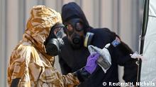FILE PHOTO: Forensic investigators, wearing protective suits, emerge from the rear of John Baker House, after it was confirmed that two people had been poisoned with the nerve-agent Novichok, in Amesbury, Britain, July 6, 2018. REUTERS/Henry Nicholls/File Photo