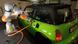 A Mini being charged by a robotic arm A Mini being charged by a robotic arm