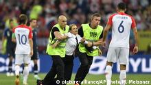 Stewards pull a member of art-punk band Pussy Riot off the pitch after she stormed onto the field and interrupted the final match between France and Croatia at the 2018 soccer World Cup in the Luzhniki Stadium in Moscow, Russia, Sunday, July 15, 2018. (AP Photo/Martin Meissner) |