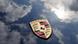 Porsche logo over clouds Porsche logo over clouds