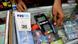 A shopkeeper swiping a card at his counter A shopkeeper swiping a card at his counter