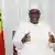 Senegal's President Macky Sall sitting beside the country's flag