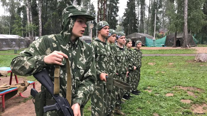 The boys at military summer camp near Moscow line up to collect their guns
