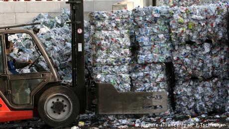 Пресовані одноразові пластикові пляшки дрібнять і переробляють на гранули для повторного виробництва