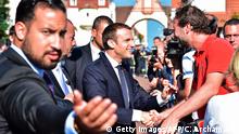 French President Emmanuel Macron (C), flanked by Elysee senior security officer Alexandre Benalla (L), shakes hands with people after he voting in Le Touquet, northern France, during the second round of the French parliamentary elections (elections legislatives in French), on June 18, 2017. (Photo by CHRISTOPHE ARCHAMBAULT / POOL / AFP) (Photo credit should read CHRISTOPHE ARCHAMBAULT/AFP/Getty Images)