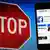 Знак "Стоп" на фоне смартфона с открытым Facebook