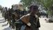Al-Shabaab fighters, one of them a young boy Al-Shabaab fighters, one of them a young boy