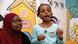 A teacher with a young girl in class A teacher with a young girl in class