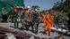 Indonesian soldiers and search and rescue teams carry the body of a victim Indonesian soldiers and search and rescue teams carry the body of a victim