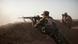 A Kurdish Peshmerga fighter firing a rifle A Kurdish Peshmerga fighter firing a rifle