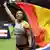 Malaika Mihambo waves the German flag after taking gold in Berlin