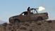 "Islamic State" fighter fires a heavy machine gun "Islamic State" fighter fires a heavy machine gun