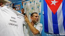 FILE PHOTO: Cuban dissident Jose Daniel Ferrer, holds up a t-shirt as he gives an interview to Reuters in his home at Palmarito de Cauto March 25, 2012. REUTERS/Mariana Bazo/File Photo