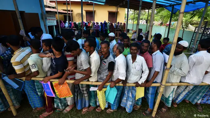 People wait in line in Assam state, India, to register as citizens