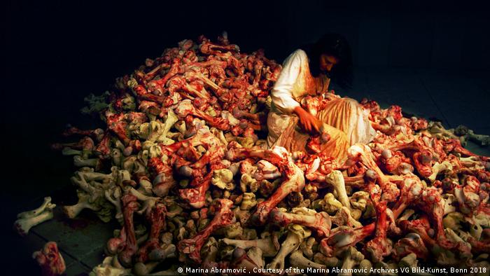 Abramovic sits in a pile of bloody bones.