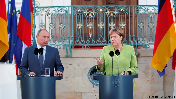 Merkel and Putin speaking to reporters before a private meeting