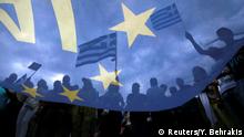 FILE PHOTO: Pro-Euro protestors hold Greek national flags during a pro-Euro rally in front of the parliament building, in Athens, Greece, June 30, 2015. Greece's conservative opposition warned on Tuesday that Sunday's vote over international bailout terms would be a referendum over the country's future in Europe, and that wages and pensions would be threatened if people were to reject the package. REUTERS/Yannis Behrakis/File Photo