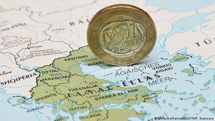 A 1 Euro coin on a map of Greece