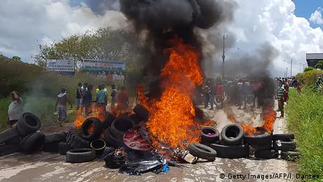 Tires burn in the streets as Brazilians attack a makeshift camp in Venezuela (Getty Images/AFP/I. Dantes)