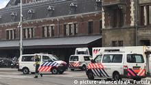 Dutch police officers near the scene of a stabbing attack near the central daily station in Amsterdam, the Netherlands, Friday Aug. 31, 2018. Police the Dutch capital shot and wounded a suspect Friday following a stabbing at the central railway station. Amsterdam police said in a series of tweets that two people were injured in the stabbing and the suspect was then shot by officers. (AP Photo/Alex Furtula) |