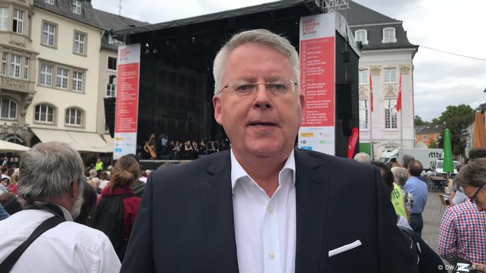 Beethovenfest 2018 (DW/R. Fulker) Middle-aged man in a suit stands in Bonn main square with the stage in background.