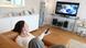A woman lying on the couch watching TV A woman lying on the couch watching TV
