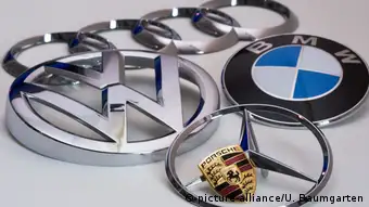 The photo shows the logos of the car manufacturers AUDI, Volkswagen, BMW, Mercedes Benz and Porsche.