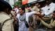 Authorities restrain a woman as she protests against fuel price hikes in Ahmedabad, India Authorities restrain a woman as she protests against fuel price hikes in Ahmedabad, India