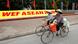 Two Vietnamese women ride their bicycles past a WEF ASEAN sign Two Vietnamese women ride their bicycles past a WEF ASEAN sign