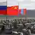 Tanques de guerra. Um deles leva a bandeira da China, um a bandeira da Rússia e um terceiro a bandeira da Mongólia. 
