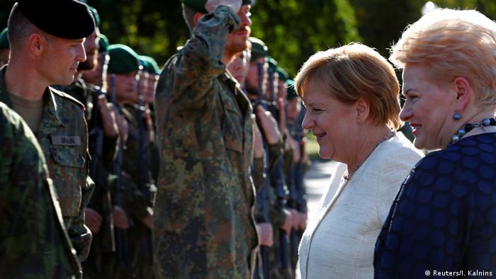 German Chancellor Angela Merkel addresses German troops of the NATO enhanced Forward Presence battle group with Lithuanian President Dalia Grybauskaite in Rukla military base, Lithuania