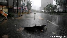 An umbrella is seen on a road after a rainstorm as Typhoon Mangkhut makes landfall in Guangdong province, in Shenzhen, China September 16, 2018. REUTERS/Jason Lee 