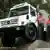 Unimog drivers pose with truck at a tesing facility in Germany