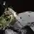 Space ship Hayabusa 2 before the background of asteroid Ryugu