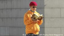 In this Dec. 2013, photo, Xiao Jianhua, a Chinese-born Canadian billionaire, reads a book outside the International Finance Centre in Hong Kong. Mystery surrounds the whereabouts of Xiao reportedly taken away from his Hong Kong hotel by mainland police, in a case that could rekindle concerns about overreach by Chinese law enforcement in the semiautonomous city. (Next Magazine via AP) |